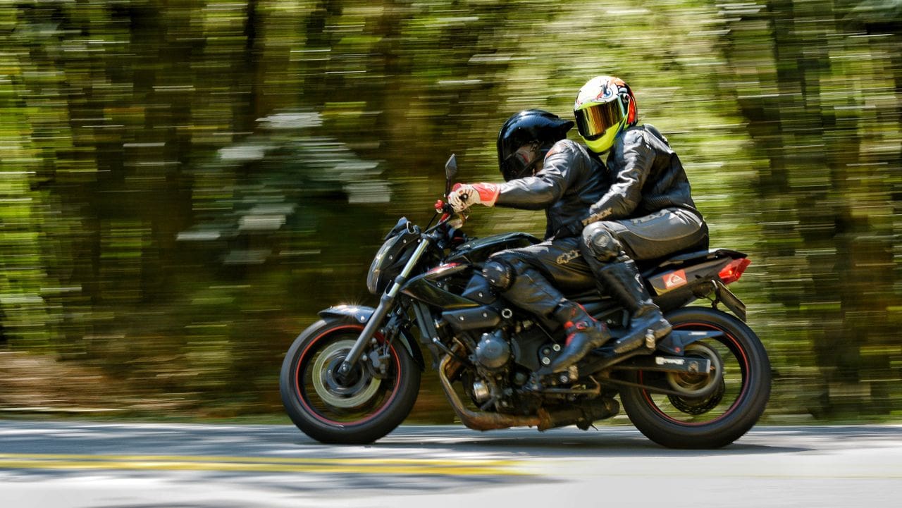 Rider on a motorcycle representing the need for proper motorcycle insurance protection.