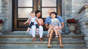 a family sitting on steps talking about life insurance in Arkansas