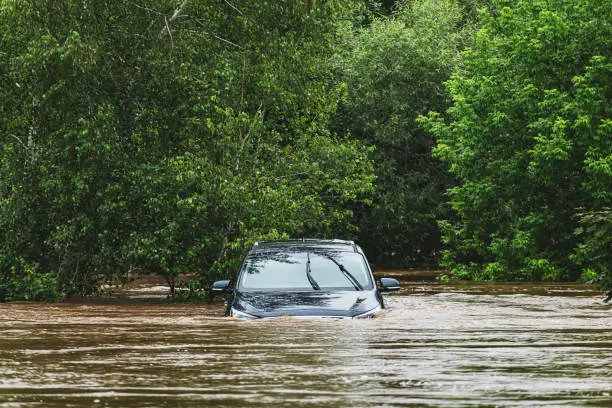 a car driving through a flooded area in Arkansas