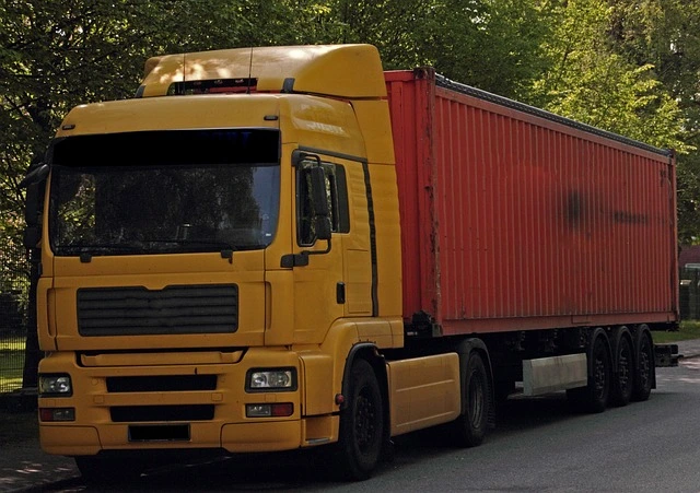 a yellow commercial box truck on the road